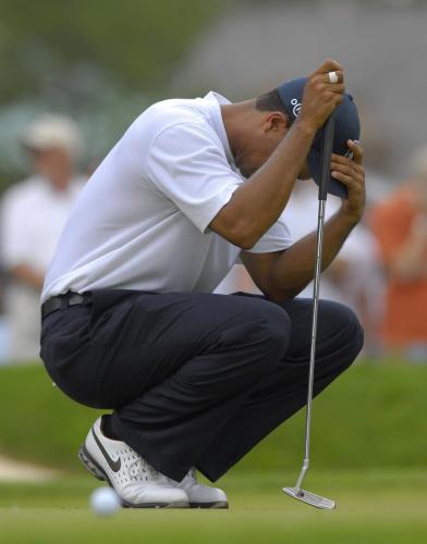 Tiger Woods of the U.S. reacts as he tries to line up his putt on the seventh hole during the third round of the Memorial Tournament at Muirfield Village Golf Club in Dublin