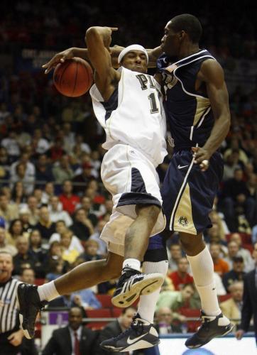 University of Pittsburgh's Gilbert Brown is fouled as he tries to shoot by East Tennessee State University's Greg Hamlin during the second half of play in their first round NCAA basketball tournament game in Dayton