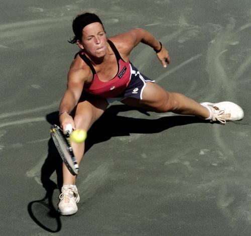 Lourdes Dominguez Lino of Spain returns a volley to Svetlana Kuznetsova of Russia during their fourth round match of the 2006 Family Circle Cup tennis tournament