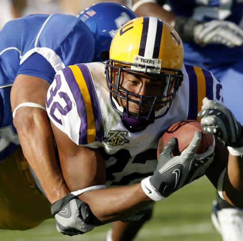 Louisiana State University's runningback Charles Scott dives in for the touchdown as he is tackled by University of Kentucky's Paul Warford during the second quarter of play at Commonwealth Stadium in Lexington