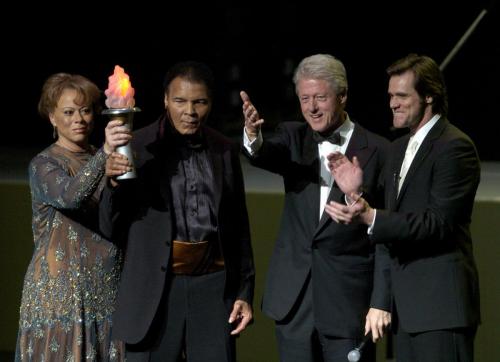 Boxing great Muhammad Ali  and his wife Lonnie Ali, former President Bill Clinton, actor Jim Carrey wave to the crowd at the end of the grand opening gala celebration for the Muhammad Ali Cente