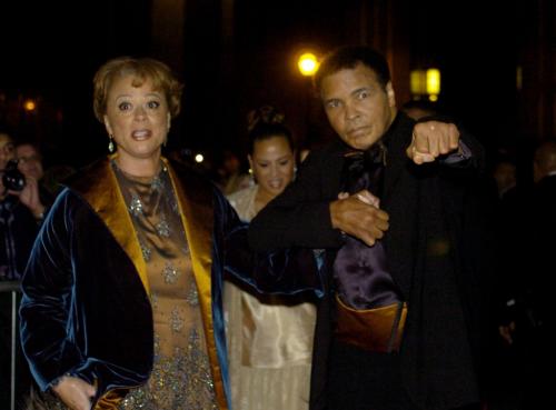 Boxing great Muhammad Ali poses for the camers with wife Lonnie Ali on the red carpet before the grand opening gala celebration for the Muhammad Ali Center