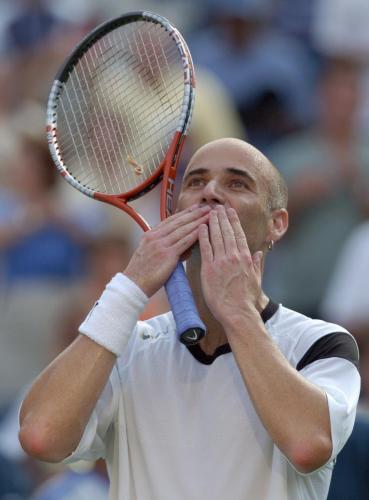 Andre Agassi blows a kiss to the crowd after defeating Jiri Novak