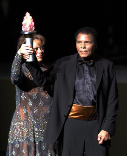 Boxing great Muhammad Ali and his wife Lonnie Ali hold up a torch at the end of the grand opening gala celebration for the Muhammad Ali Center