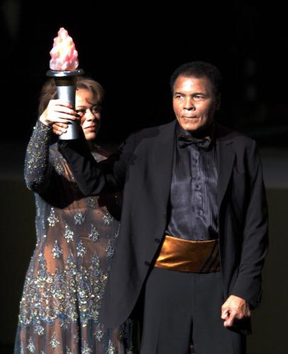Boxing great Muhammad Ali and his wife Lonnie Ali hold up a torch at the end of the grand opening gala celebration for the Muhammad Ali Center